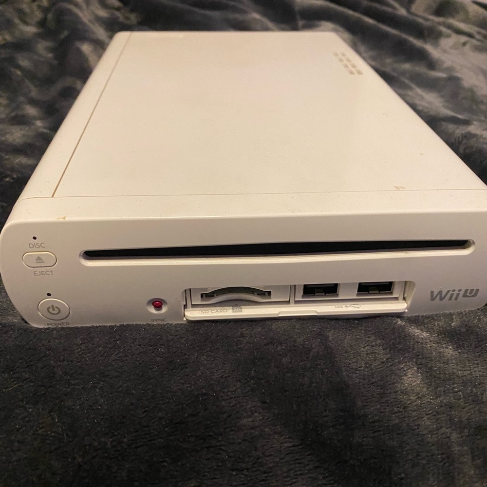 Wii U + Wii ucontroller with all cords and 5 games